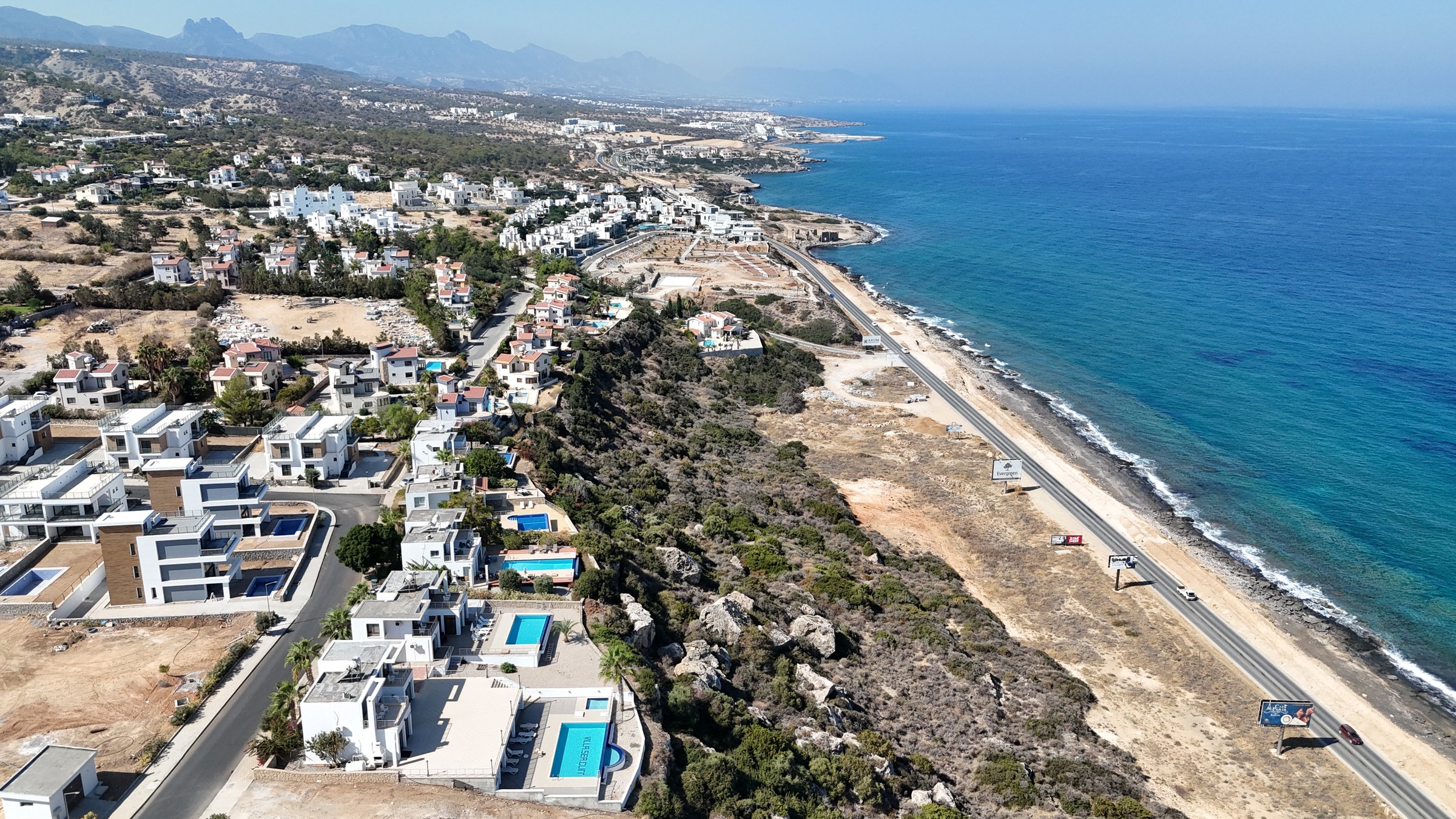 Seafront villas with private pools along the coast road